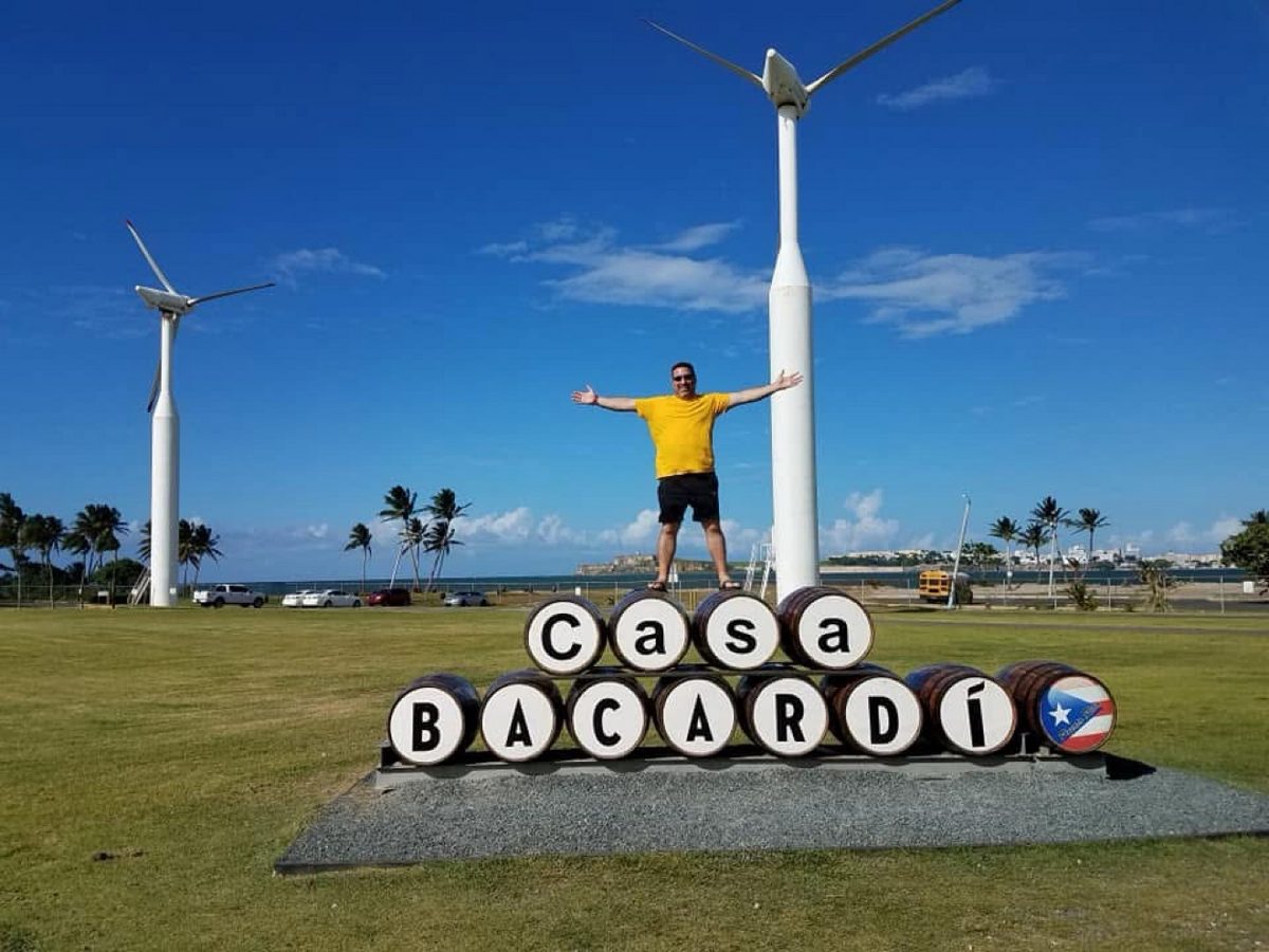 Visitor posing beside the Casa Bacardí barrel sign