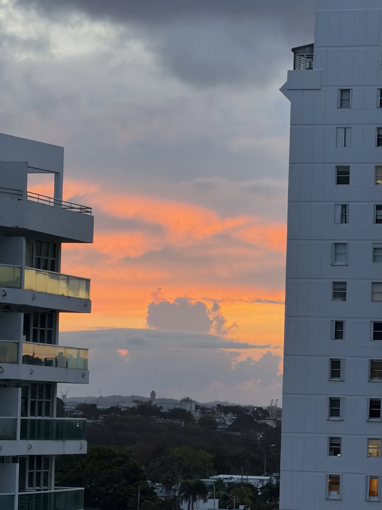 Orange sunset framed by the Isla Verde skyline