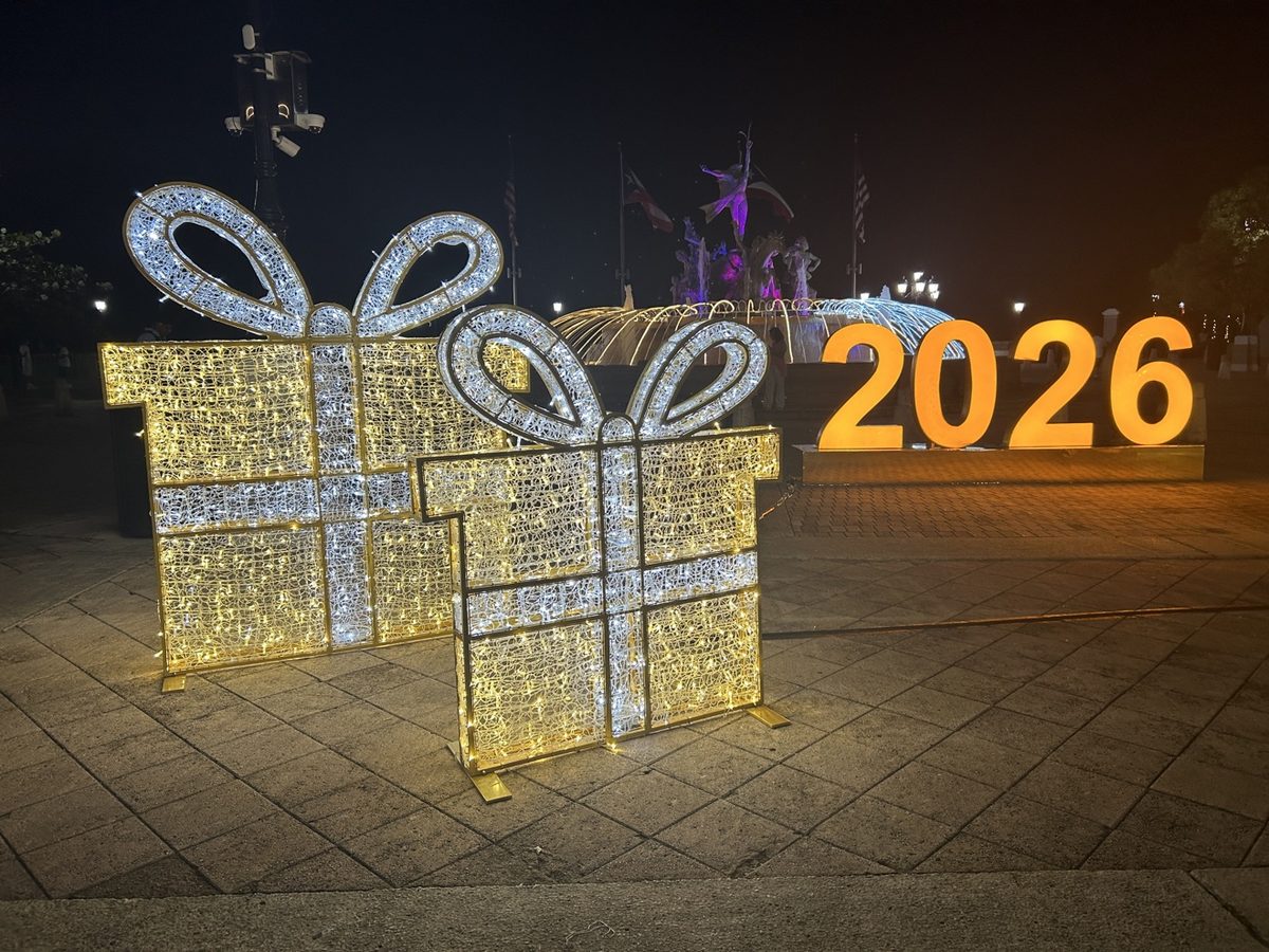 Illuminated gift-box light displays and a 2026 sign in Old San Juan