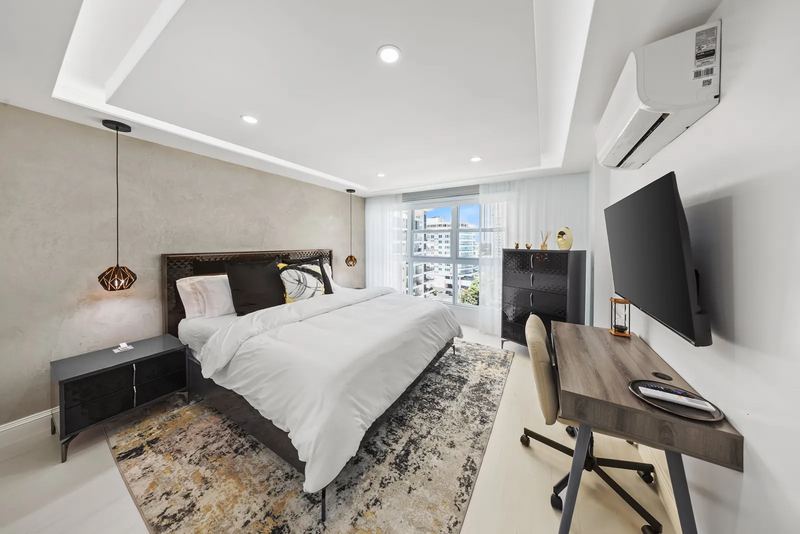 Terra Noir bedroom with king bed and workspace